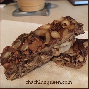 A piece of granola on a napkin next to a cup of coffee, perfect for those looking for a paleo snack.