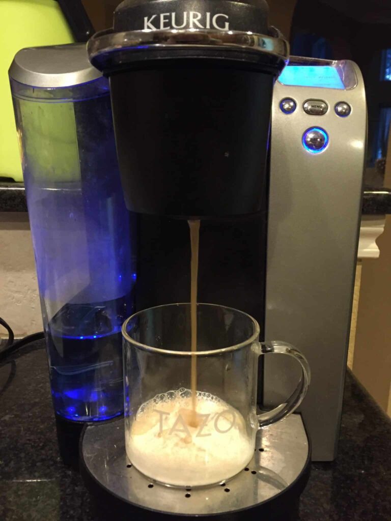 A keurig coffee maker with a cup of coffee.