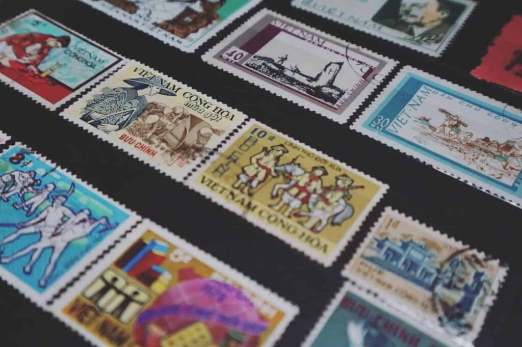 A collection of postage stamps from Vietnam displayed on a black background, showcasing various designs and illustrations.