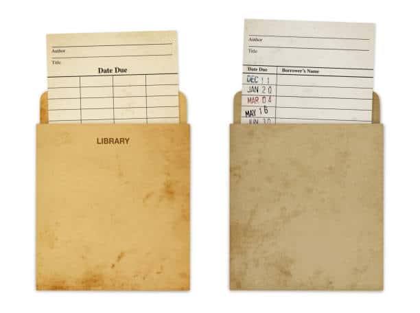 Two library card pockets with date due slips showing past return dates. One pocket is labeled "LIBRARY," both have a worn appearance.