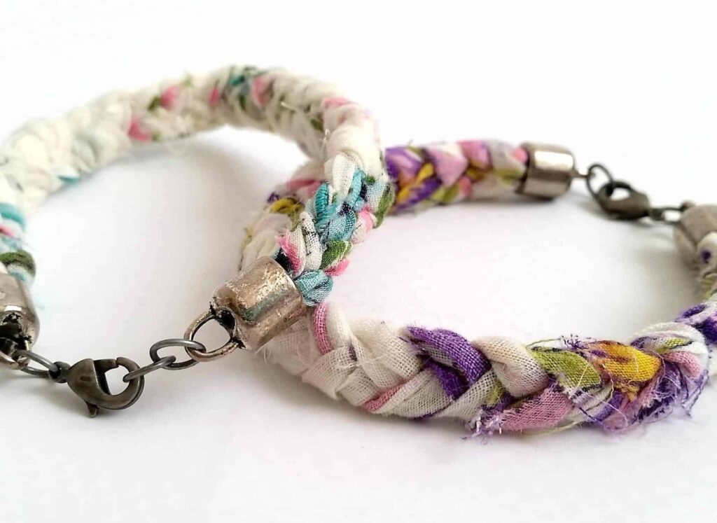 Two braided fabric bracelets with floral patterns and metal clasps on a white background.