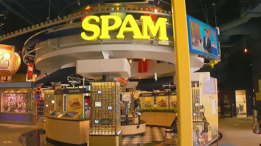Interior of the SPAM Museum with displays and bright yellow signage showcasing SPAM products.
