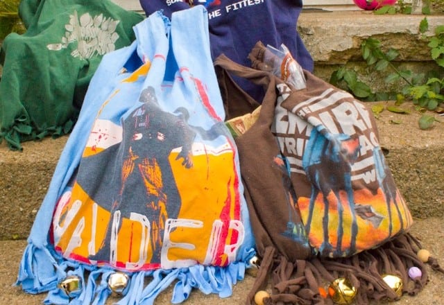 Colorful drawstring bags featuring Star Wars-themed prints are sitting on stone steps.