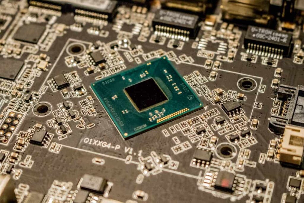 Close-up of a computer motherboard featuring a central processing unit (CPU) in the center surrounded by various electronic components and circuitry.