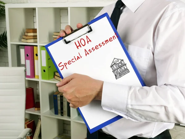 A person in a white shirt holds a clipboard with "HOA Special Assessment" and a house sketch.
