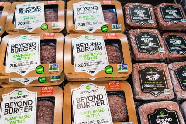 Packages of Beyond Burger and Beyond Beef plant-based patties displayed on a shelf.