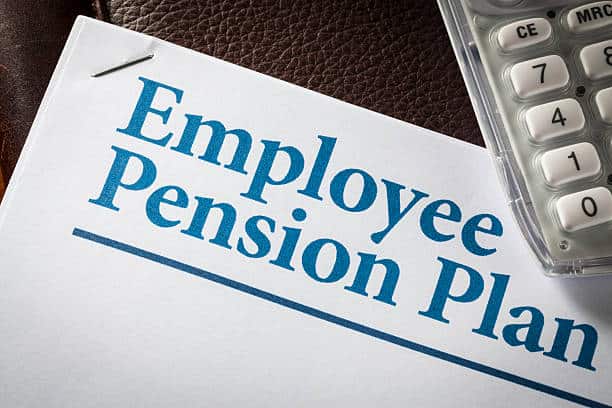Close-up of a document titled "Employee Pension Plan" next to a calculator on a leather surface.
