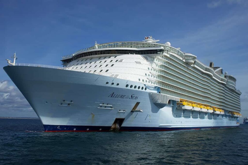 Large cruise ship in calm waters under a blue sky.