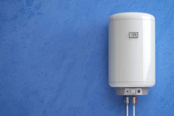 White electric water heater mounted on a blue wall, with visible controls and piping at the bottom.