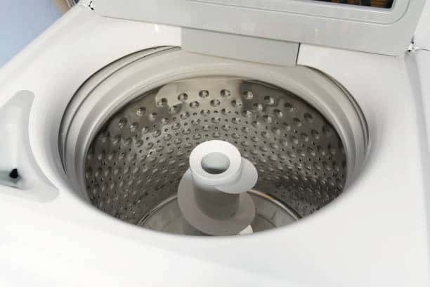 Top-load washing machine with an open lid, showing the empty stainless steel drum and central agitator.